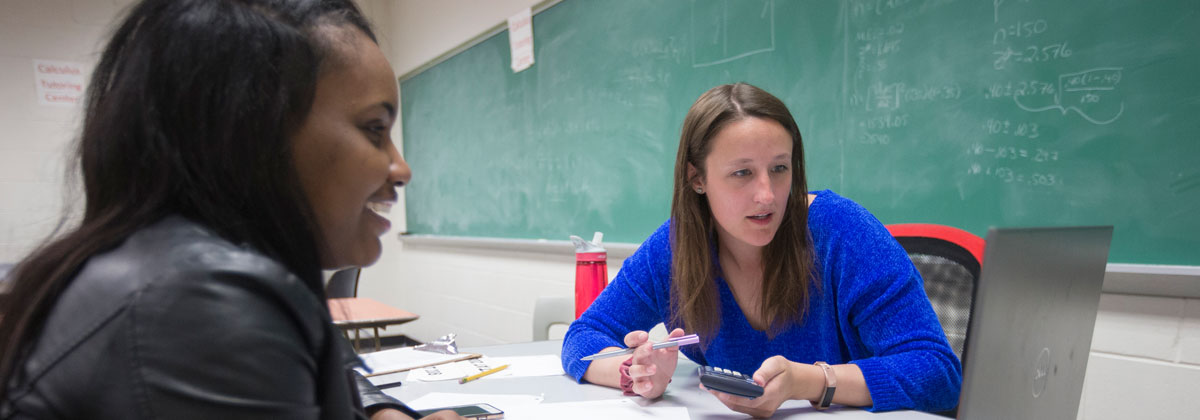 NIU students discussing mathematics.