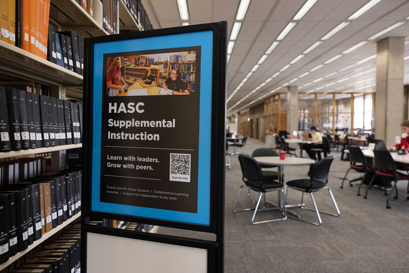 Students at tables in the supplemental instruction area